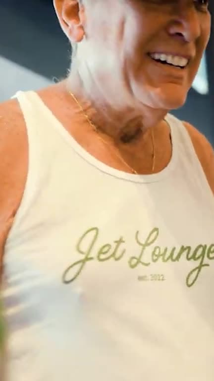 A guest in a Jet Lounge shirt at the tailgate, shot vertically for social