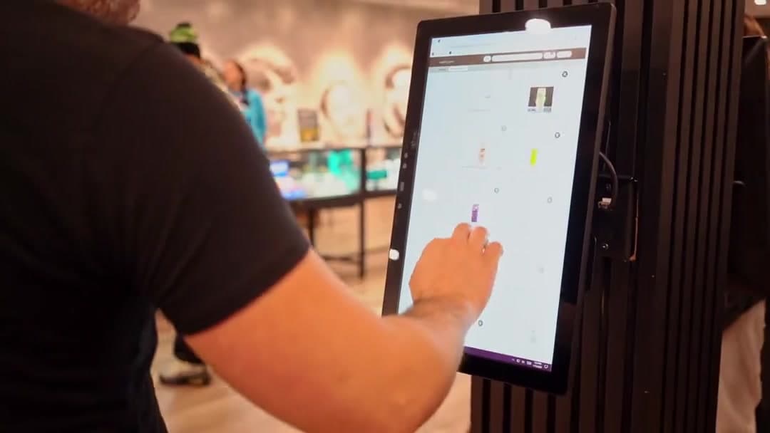 A customer browsing the menu on an in-store screen